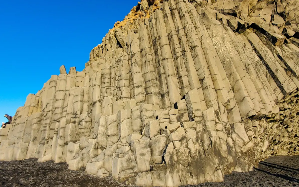Hexagonal basalt columns in a dark cliff on the South Coast